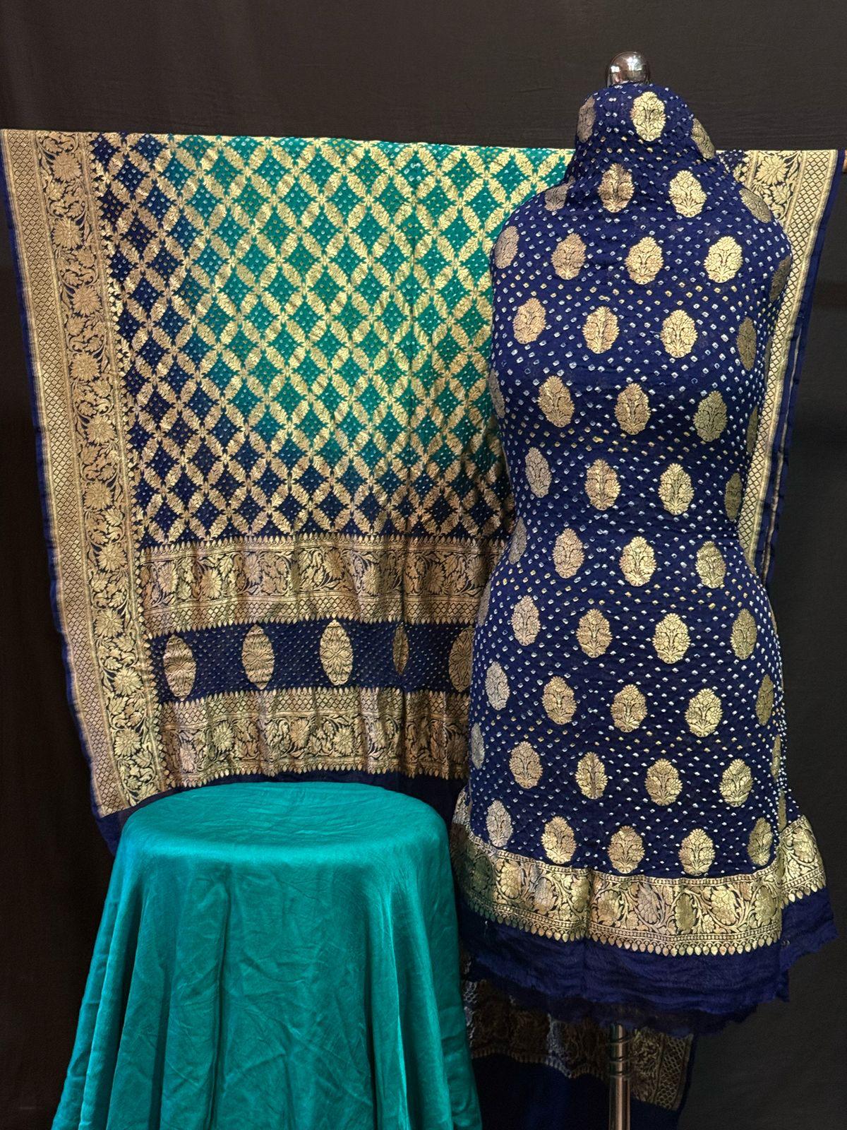 Navy blue Banarasi saree with golden zari motifs and contrast teal pallu displayed on a mannequin