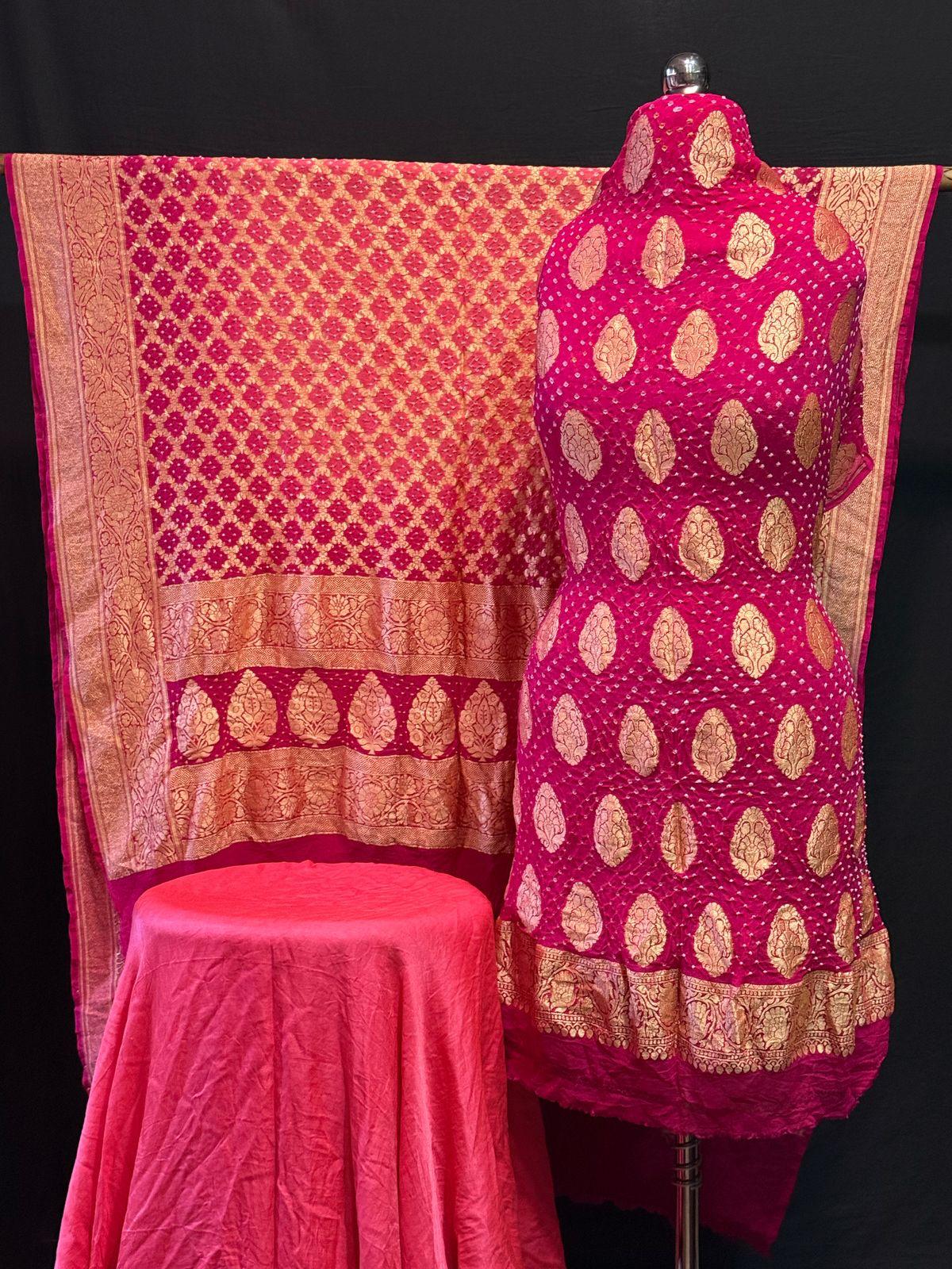 "Pink Banarasi unstitched suit set with golden zari booti and matching dupatta displayed on mannequin"