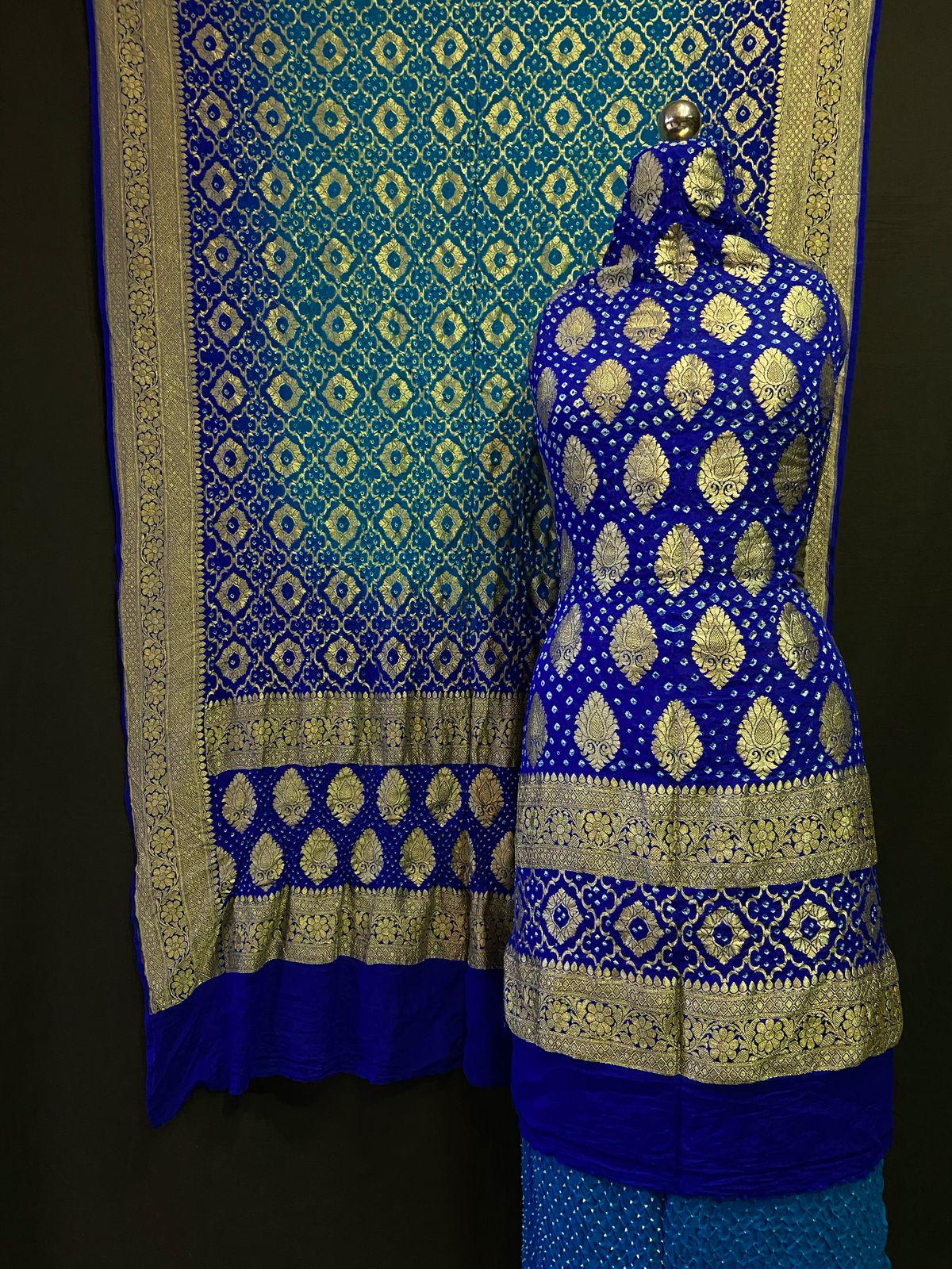 Royal blue Banarasi saree with golden zari booti and rich pallu displayed on a mannequin

