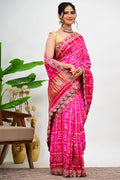 Hot pink bandhani saree with gold embroidery