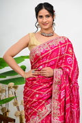 Magenta silk saree with gold zari floral embroidery
